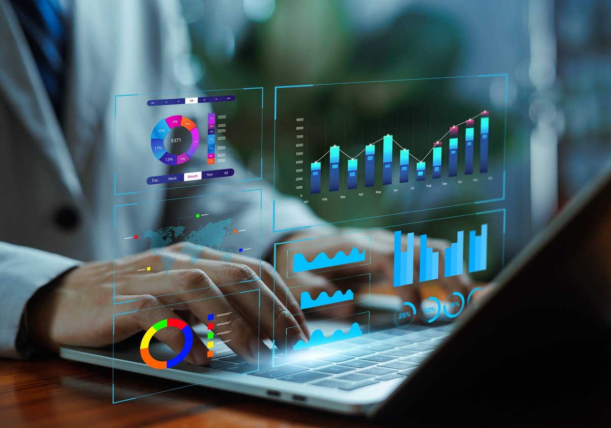 Digital business analytics dashboard with charts and graphs over a laptop